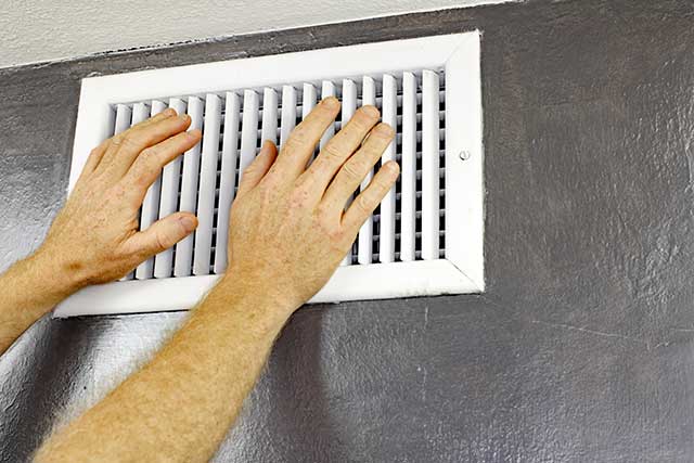 hands in front of air vent