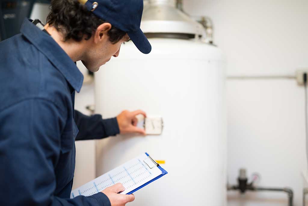 Plumber inspecting residential water heater